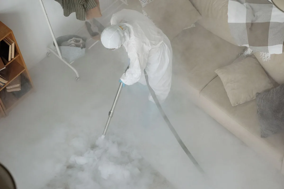 Biohazard cleanup technician in protective equipment, Kennett, MO